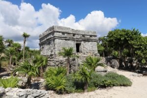 Explore the historic Mayan ruins amid lush vegetation in Tulum, Mexico.